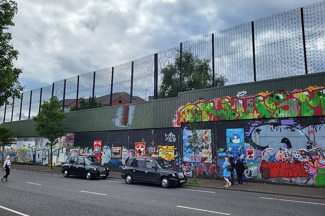 Belfast history of terror & mural 1 hr express private taxi tour - International mural wall on Divis Street: messages beyond Belfast